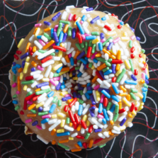 Aww Shucks - Honey glaze and rainbow sprinkles donut.